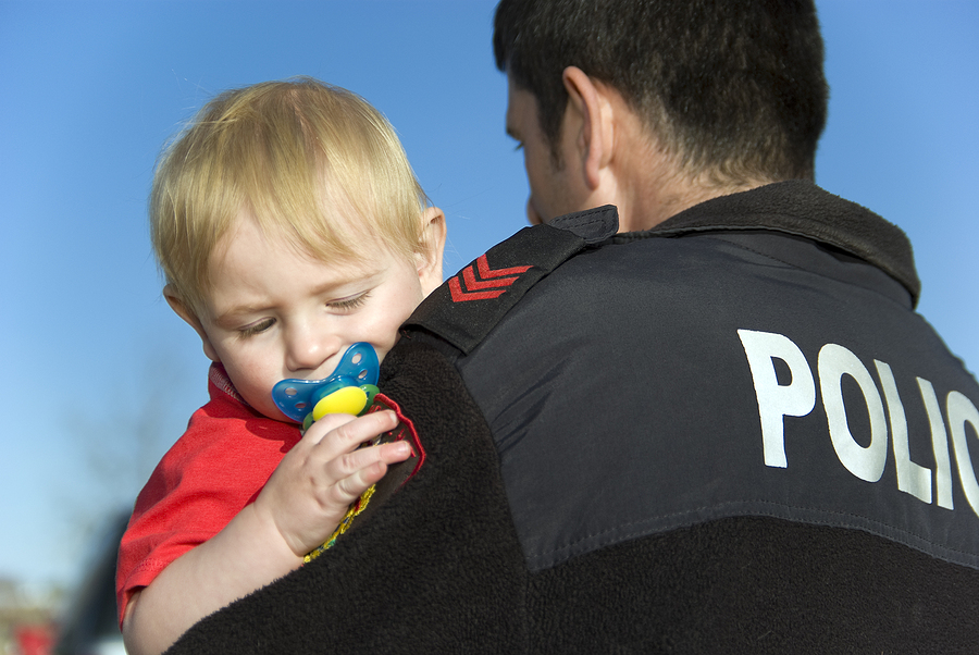 bigstock-Police-Officer-Holds-Baby-5578641